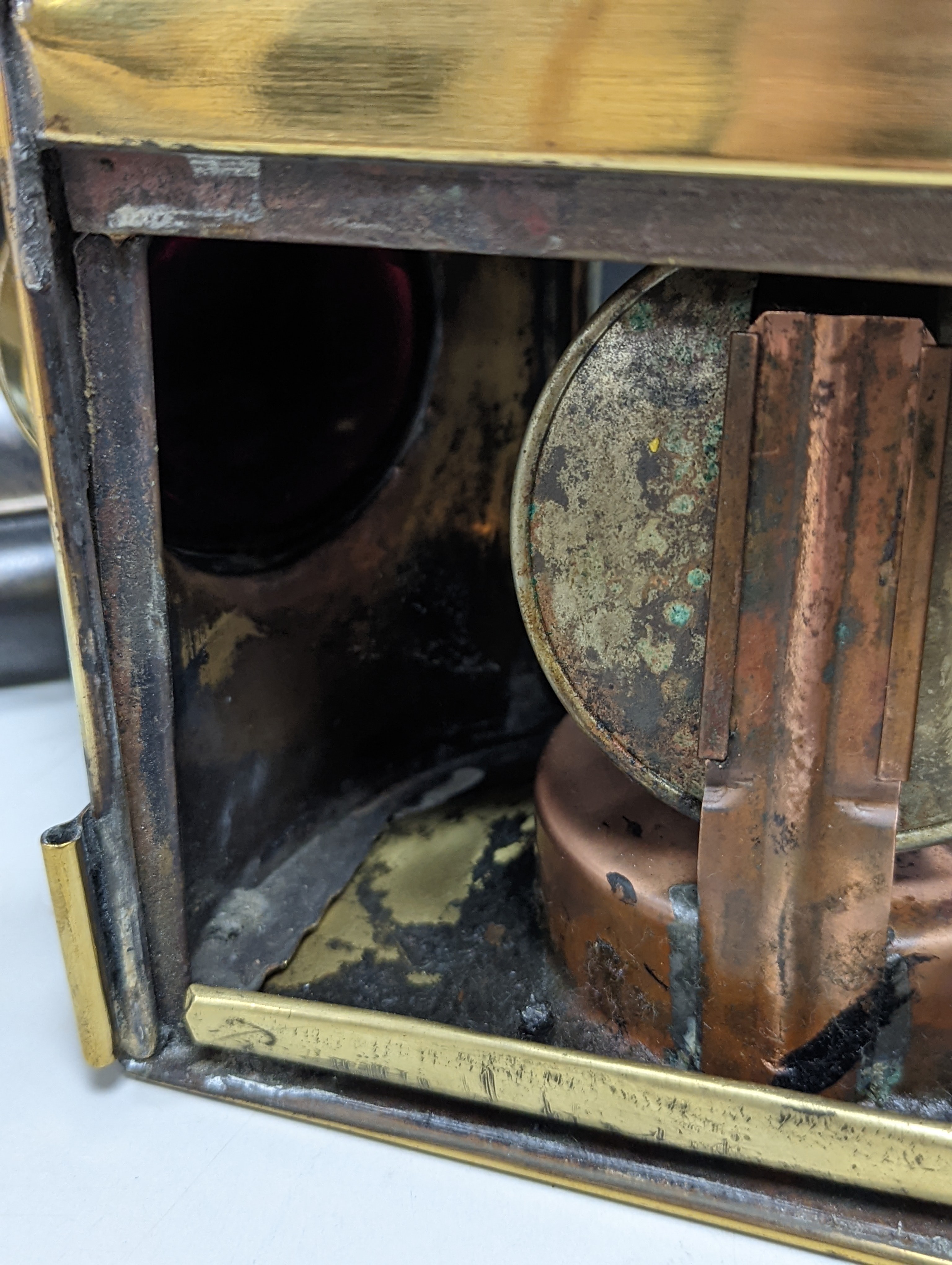 A copper ship's binnacle compass, a brass oil lamp, a brass jug and a copper kettle